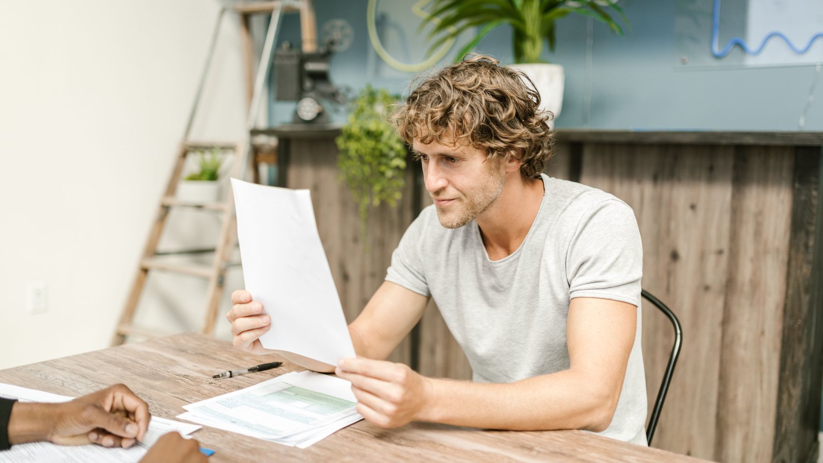 Reviewing investment and visa documents at a desk